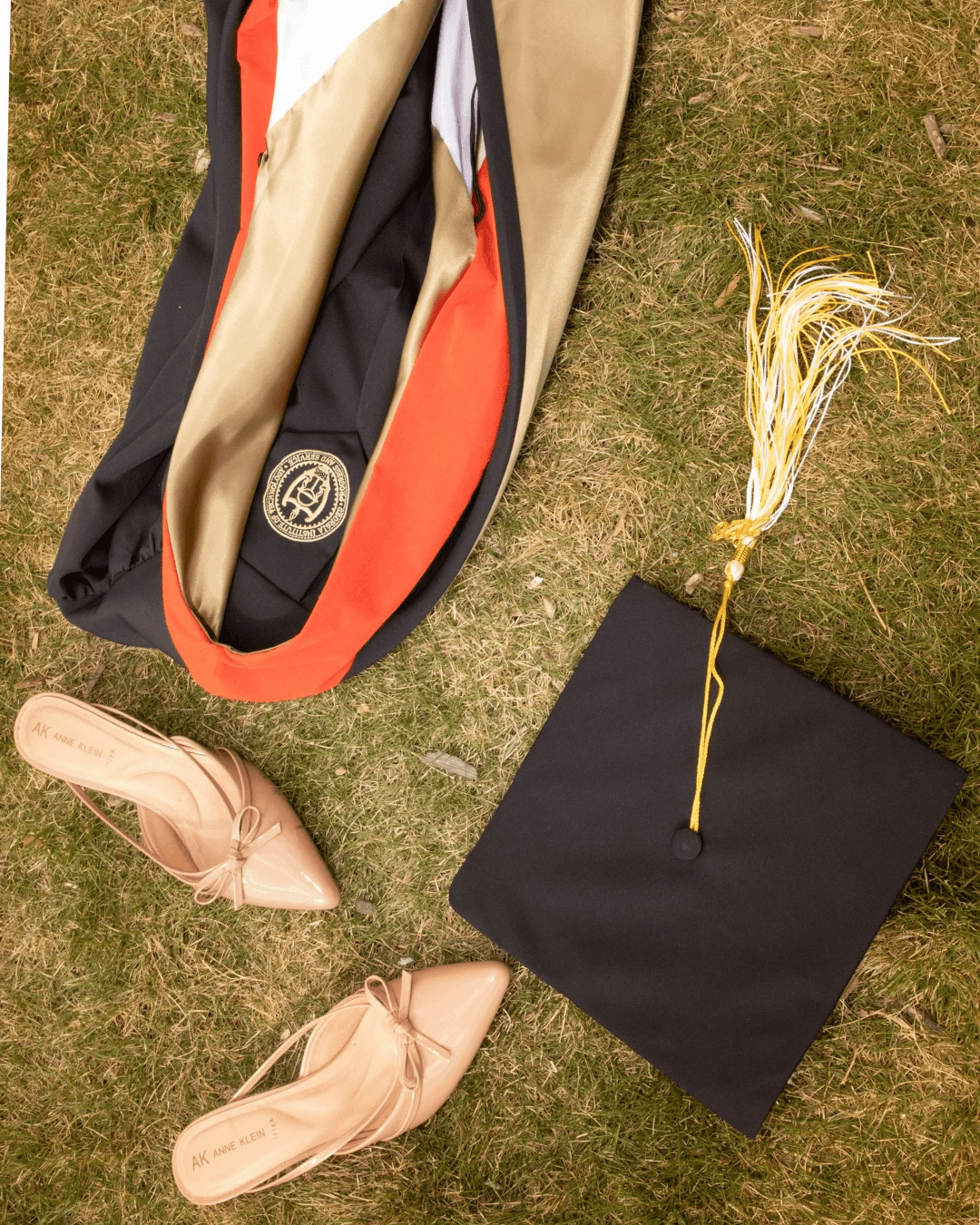 Graduate posing outdoors in cap and gown